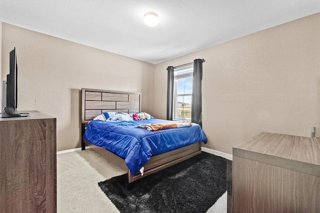 carpeted bedroom with baseboards