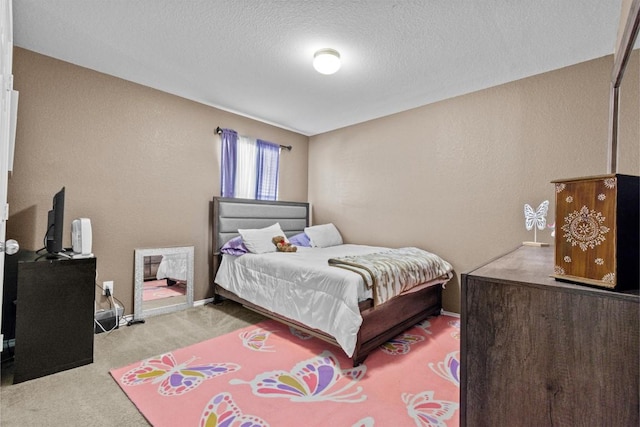 bedroom featuring carpet flooring, a textured ceiling, and baseboards