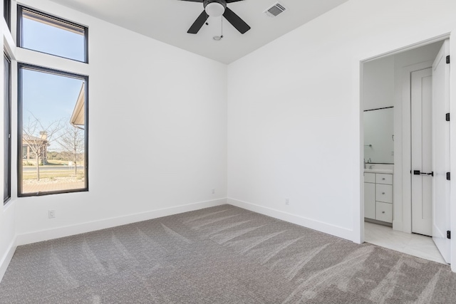 unfurnished bedroom featuring multiple windows, carpet flooring, and visible vents