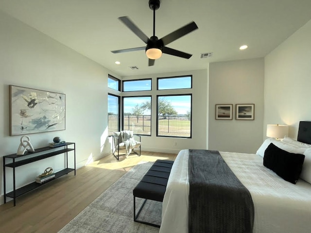 bedroom with a ceiling fan, recessed lighting, visible vents, and wood finished floors