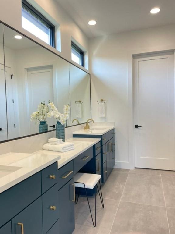 full bath with double vanity, tile patterned flooring, a sink, and recessed lighting