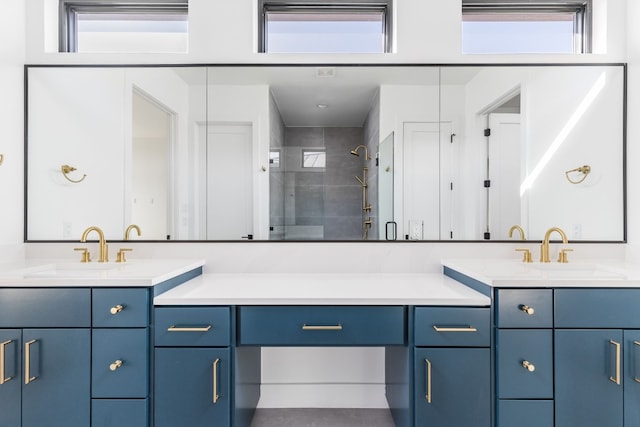 bathroom with plenty of natural light, tiled shower, and a sink