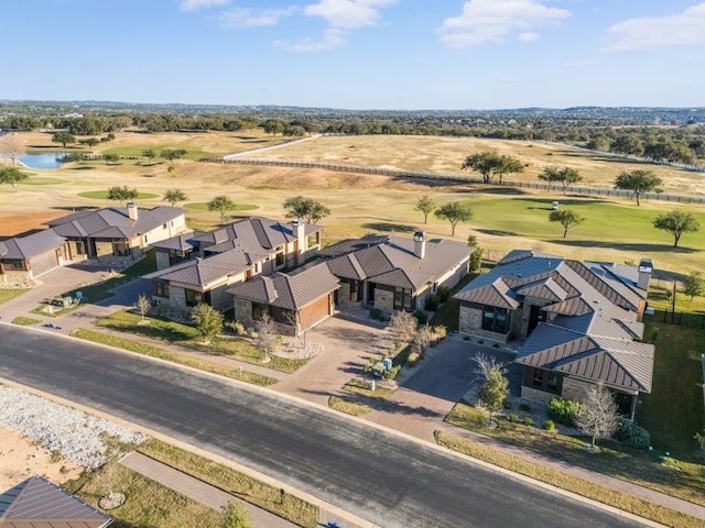 birds eye view of property with a water view, view of golf course, and a residential view