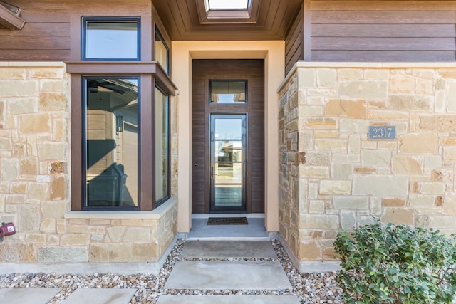 property entrance featuring stone siding