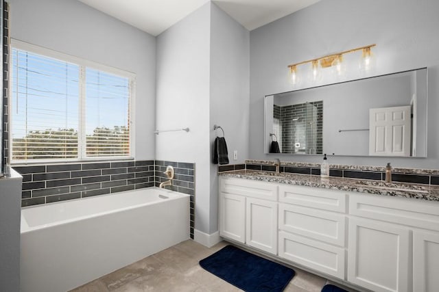 3660 Stagecoach Ranch Loop, Dripping Springs, TX 78620 - full bathroom featuring tile patterned floors, double vanity, a shower with shower door, and a garden tub
