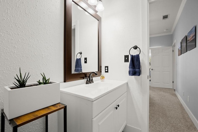 3660 Stagecoach Ranch Loop, Dripping Springs, TX 78620 - bathroom featuring visible vents, baseboards, ornamental molding, a textured wall, and vanity