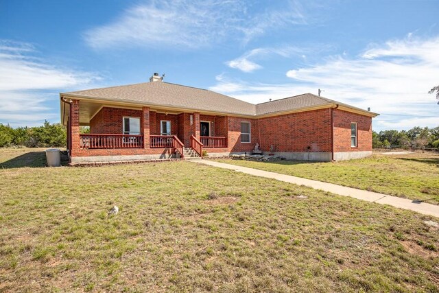 3660 Stagecoach Ranch Loop, Dripping Springs, TX 78620 - back of property with roof with shingles, a yard, covered porch, and brick siding