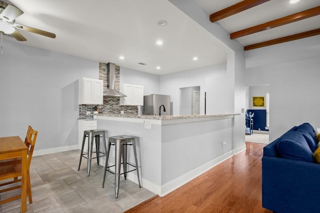 3660 Stagecoach Ranch Loop, Dripping Springs, TX 78620 - kitchen with freestanding refrigerator, wall chimney exhaust hood, tasteful backsplash, white cabinets, and recessed lighting