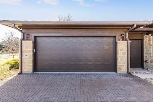 garage with decorative driveway