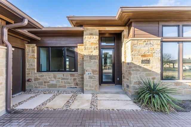 view of exterior entry featuring stone siding