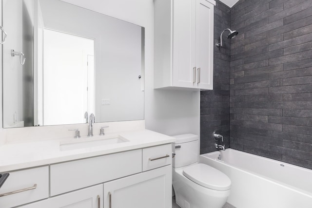 bathroom with washtub / shower combination, vanity, and toilet