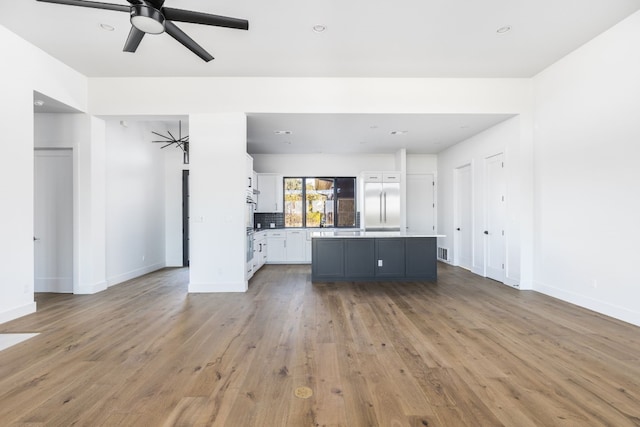 unfurnished living room with visible vents, baseboards, ceiling fan, wood finished floors, and recessed lighting