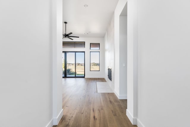 hallway with baseboards and wood finished floors