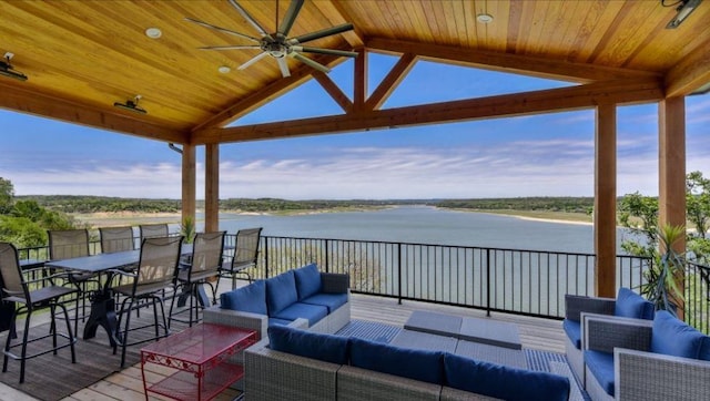 deck featuring ceiling fan, a water view, and an outdoor living space