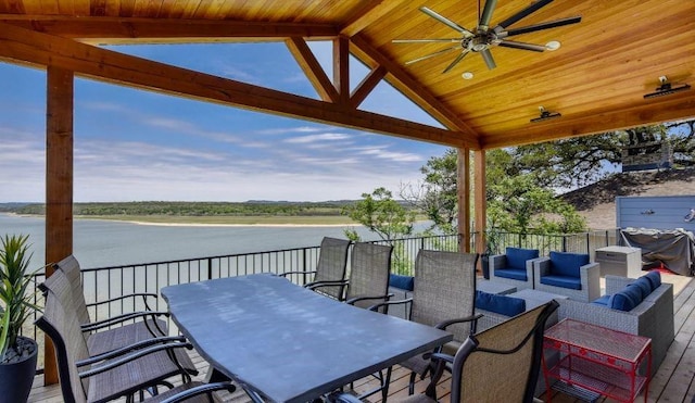 view of patio / terrace featuring an outdoor hangout area, outdoor dining area, a water view, and a ceiling fan