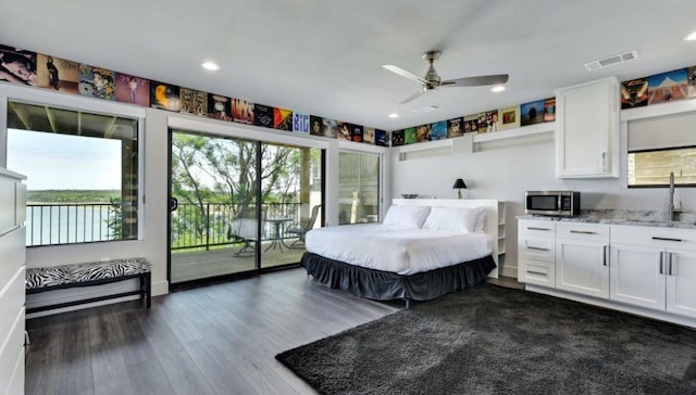 bedroom featuring access to outside, multiple windows, visible vents, and dark wood-type flooring