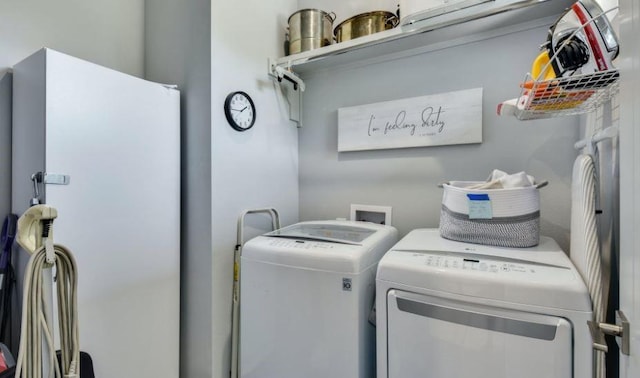 clothes washing area with laundry area and independent washer and dryer