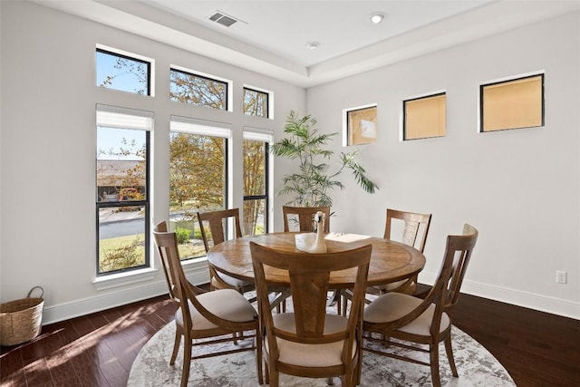 dining space featuring baseboards, visible vents, and hardwood / wood-style floors