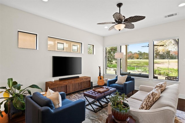 living area with recessed lighting, visible vents, a ceiling fan, wood finished floors, and baseboards