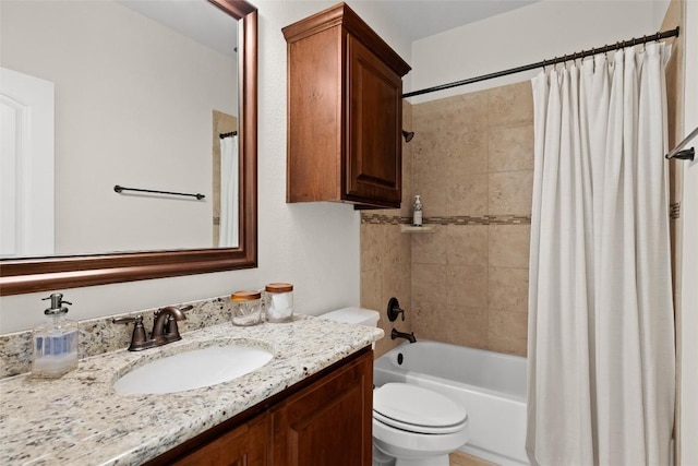 full bathroom featuring vanity, shower / bathtub combination with curtain, and toilet