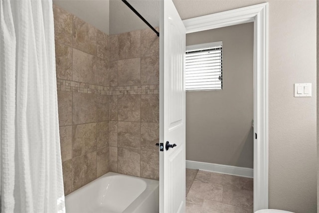 bathroom featuring shower / bathtub combination with curtain and baseboards