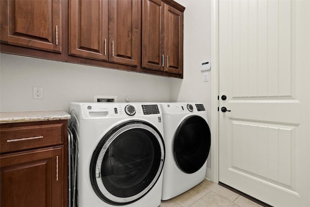 clothes washing area featuring cabinet space and washing machine and dryer