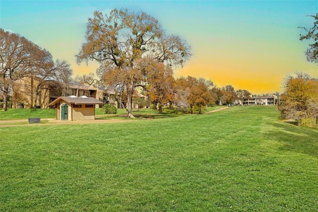 view of home's community with a yard and an outdoor structure