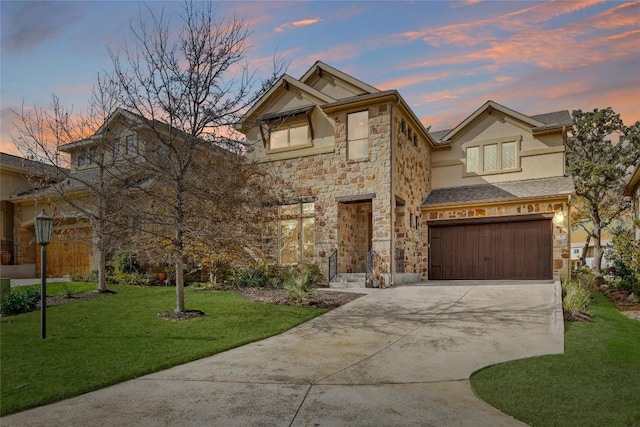 traditional home with stone siding, a garage, stucco siding, a front yard, and driveway