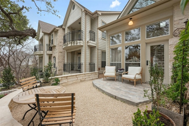 view of patio featuring a balcony