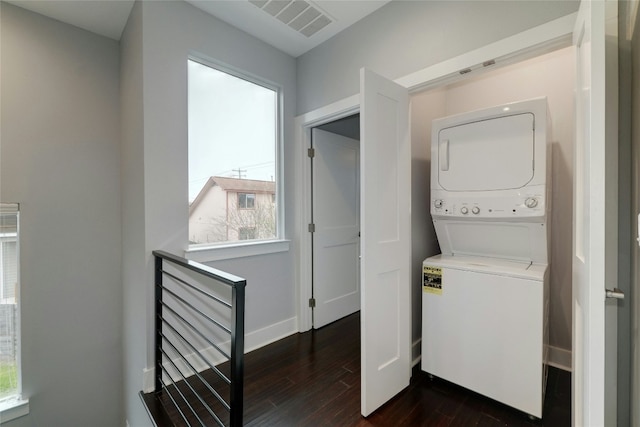 6902 Carver Ave Unit B, Austin, TX 78752 - washroom featuring stacked washer / drying machine, dark wood-style flooring, and baseboards
