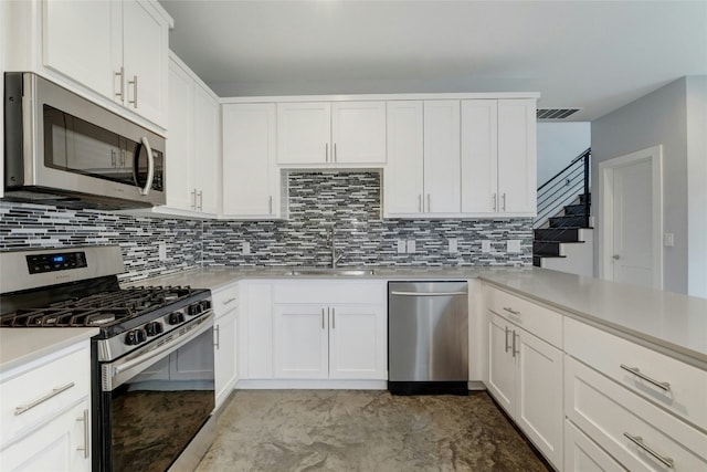 6902 Carver Ave Unit B, Austin, TX 78752 - kitchen with stainless steel appliances, tasteful backsplash, light countertops, a sink, and white cabinets