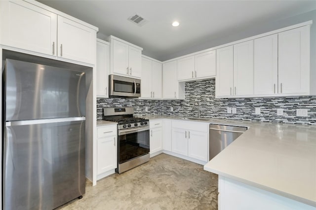 6902 Carver Ave Unit B, Austin, TX 78752 - kitchen featuring stainless steel appliances, light countertops, a sink, white cabinets, and recessed lighting