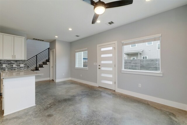 6902 Carver Ave Unit B, Austin, TX 78752 - entrance foyer with finished concrete flooring, stairway, a ceiling fan, baseboards, and recessed lighting