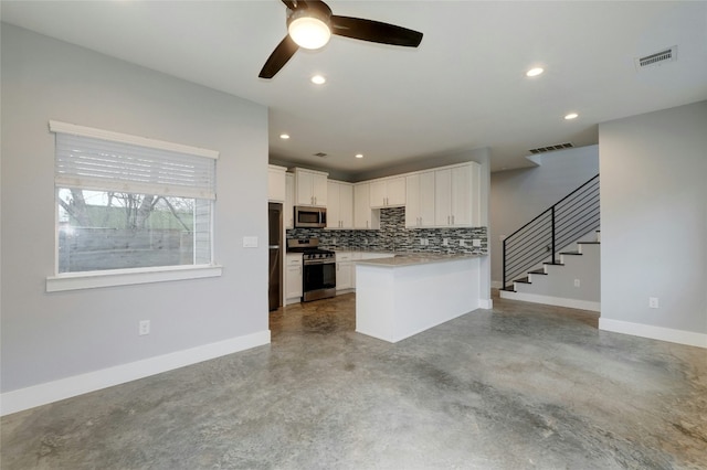 6902 Carver Ave Unit B, Austin, TX 78752 - kitchen with appliances with stainless steel finishes, finished concrete flooring, a ceiling fan, tasteful backsplash, and open floor plan