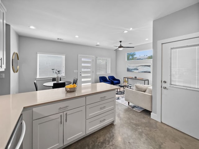 6902 Carver Ave Unit B, Austin, TX 78752 - kitchen with concrete flooring, a ceiling fan, light countertops, recessed lighting, and stainless steel dishwasher