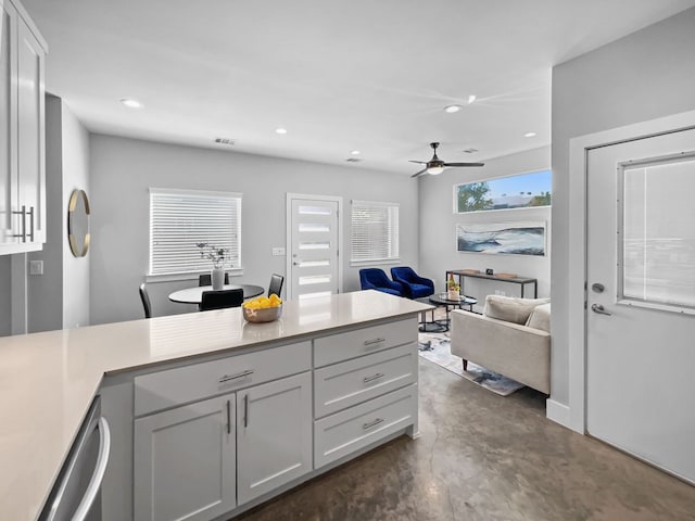 6902 Carver Ave Unit B, Austin, TX 78752 - kitchen with finished concrete flooring, light countertops, ceiling fan, recessed lighting, and open floor plan