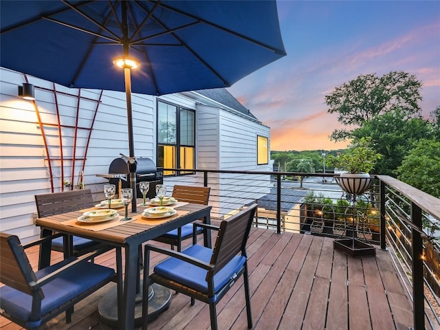 wooden deck featuring outdoor dining space and grilling area