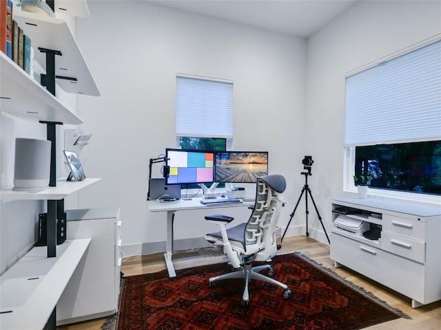 office area with light wood finished floors and baseboards