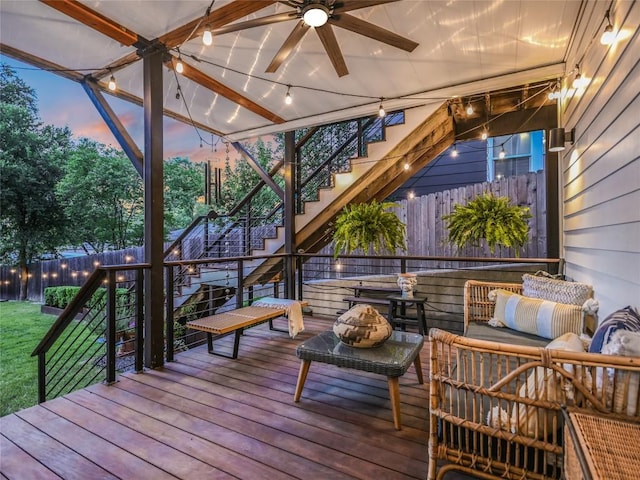 wooden terrace with fence, stairway, outdoor lounge area, and a ceiling fan