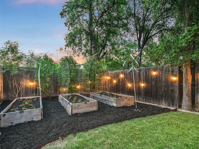 view of yard featuring a garden and a fenced backyard