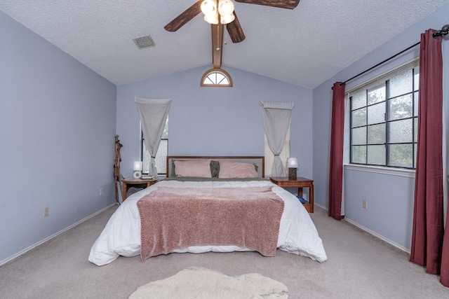 bedroom with vaulted ceiling with beams, a textured ceiling, visible vents, and carpet flooring