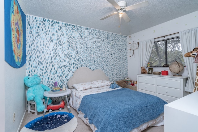 bedroom featuring a textured ceiling, ceiling fan, and light colored carpet