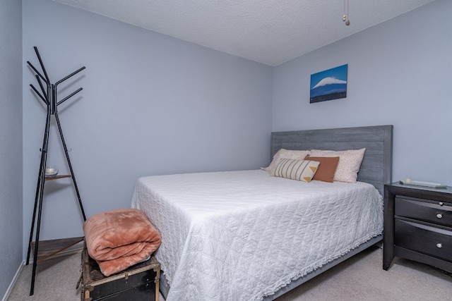 bedroom featuring a textured ceiling and carpet flooring