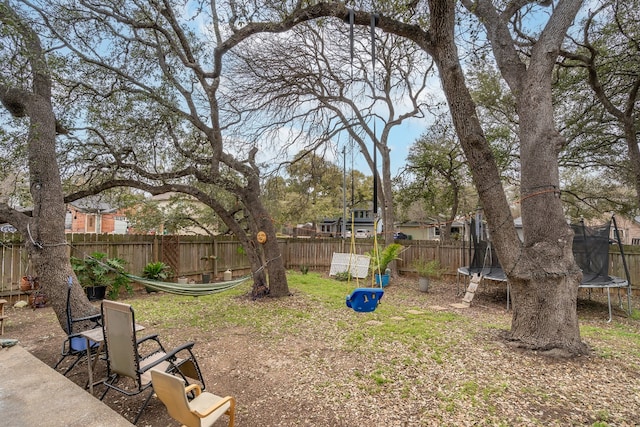 view of yard featuring a fenced backyard and a trampoline