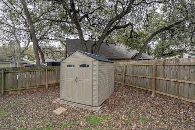 view of shed with a fenced backyard