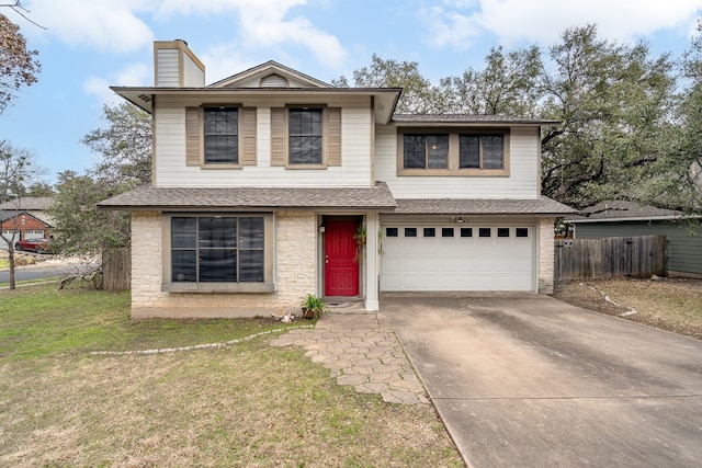 traditional-style home featuring a chimney, an attached garage, a front yard, fence, and driveway