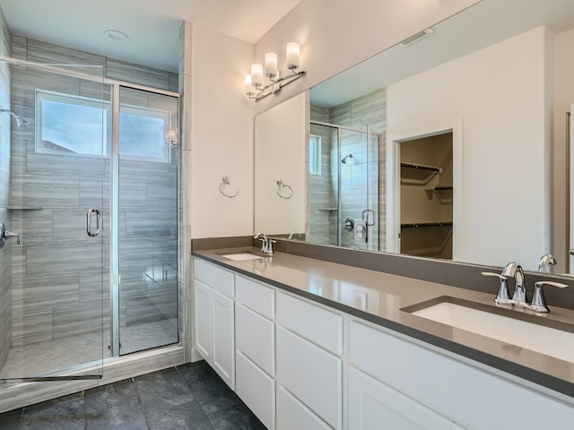 bathroom with double vanity, a sink, visible vents, and a shower stall