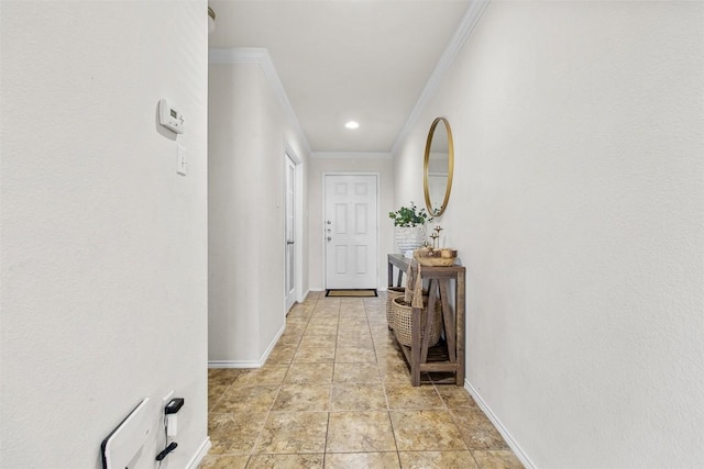 hallway featuring baseboards and ornamental molding