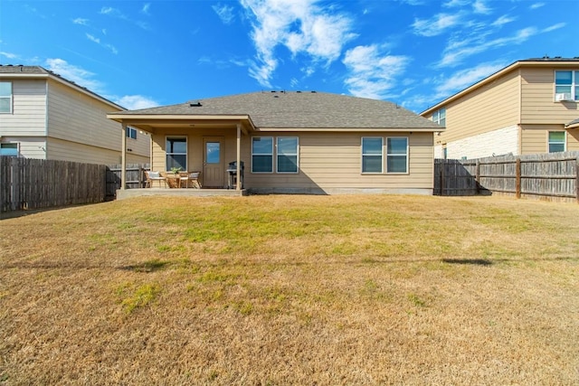 back of property featuring a fenced backyard, a patio, and a yard