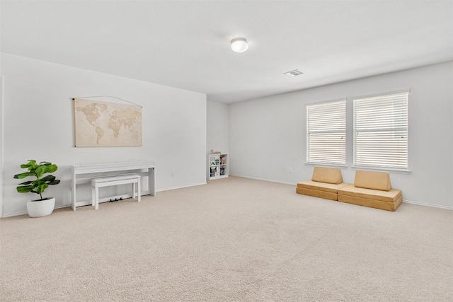 sitting room featuring carpet floors, visible vents, and baseboards